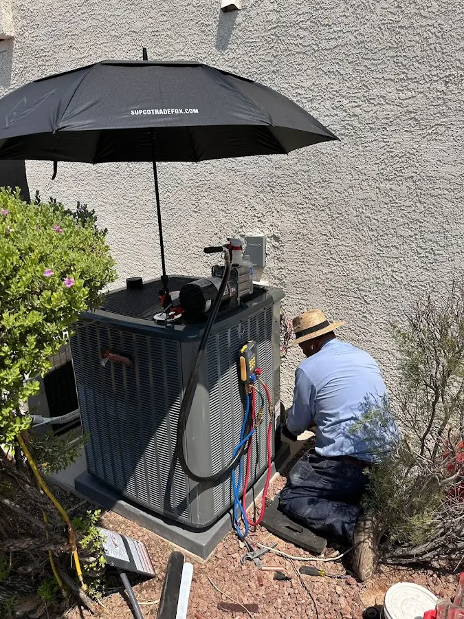 HVAC technician performing outdoor AC maintenance in Tallmadge
