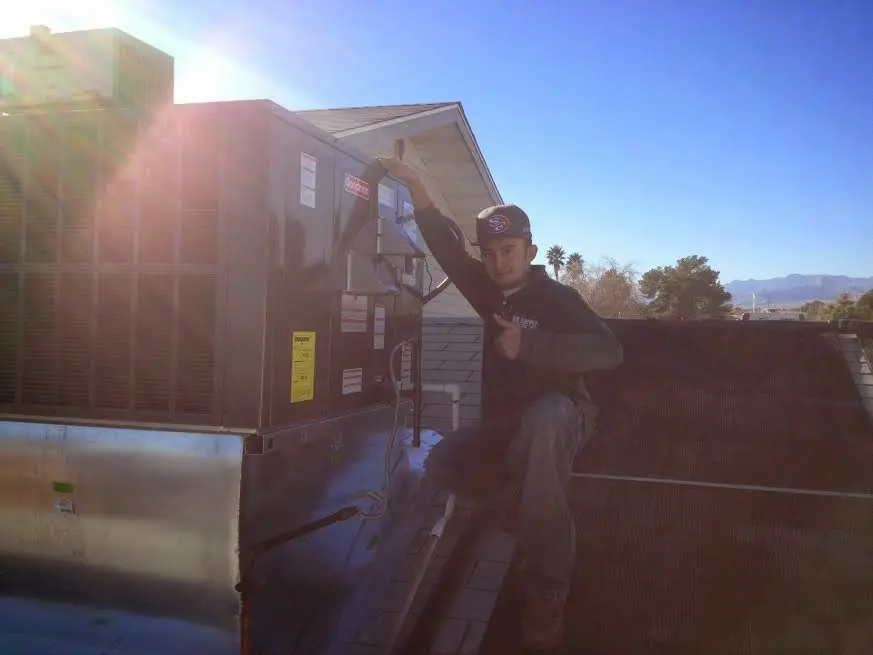 HVAC technician performing HVAC Inspection on a rooftop unit in Tallmadge